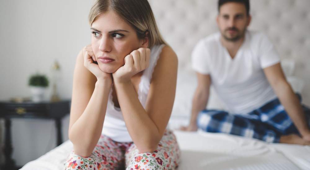 Woman experiencing emotional distance in relationship, representing low libido and its impact on couples and fertility